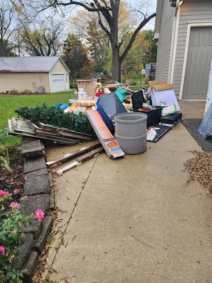 Dumpster being loaded with debris for 10 Yard Dumpster Rental in Minnetonka